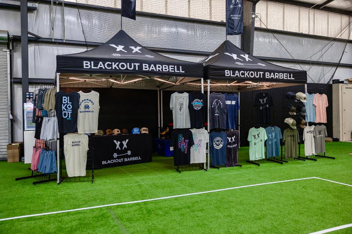 BLACKOUT BARBELL competition booth at a powerlifting meet